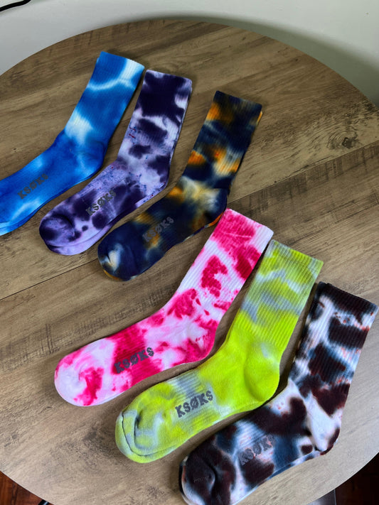 Colorful tie-dye socks on a wooden surface